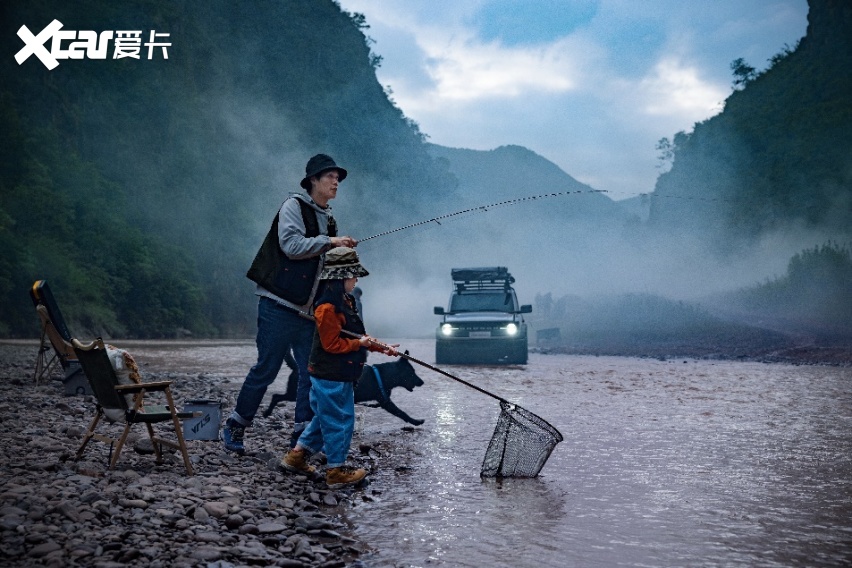 A person and child fishing in a river

Description automatically generated